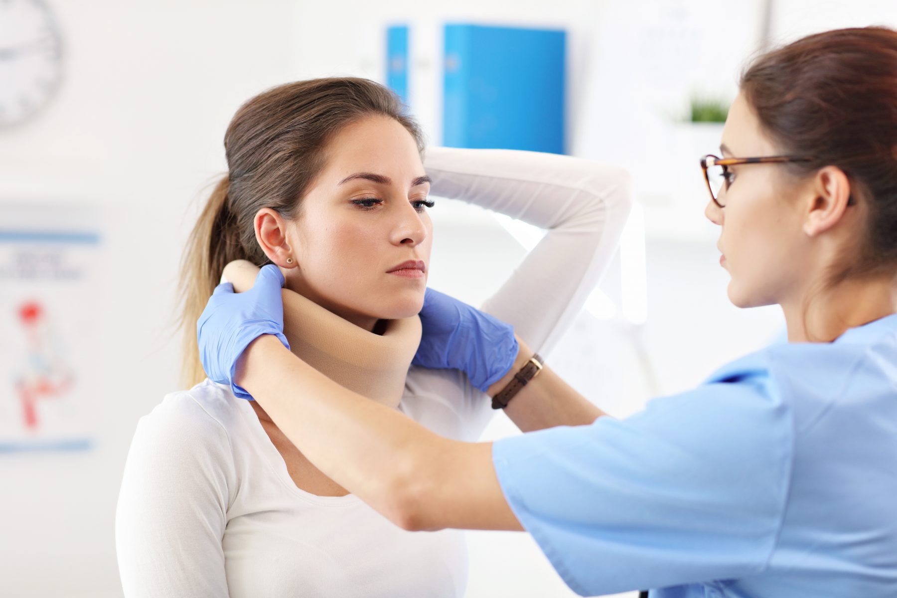 photo of woman being outfitted with neck brace relating to long-term disability and ERISA claims